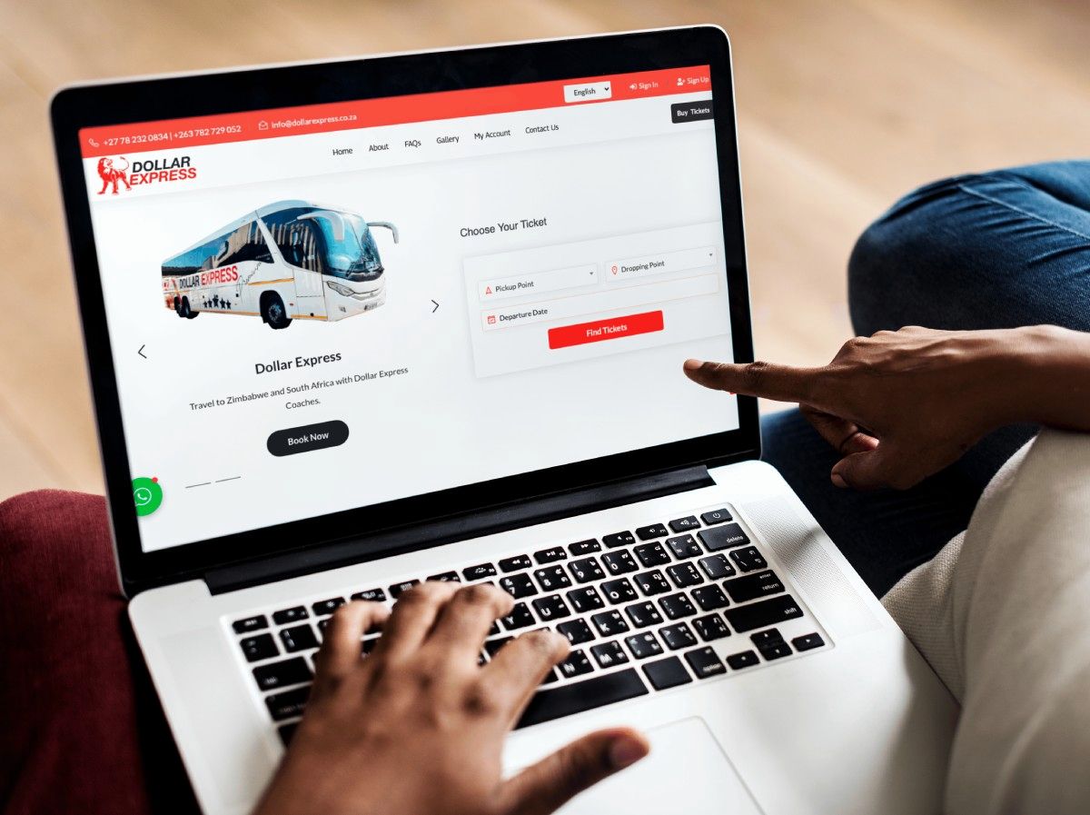 Dollar Express Coaches bus booking system shown on a laptop