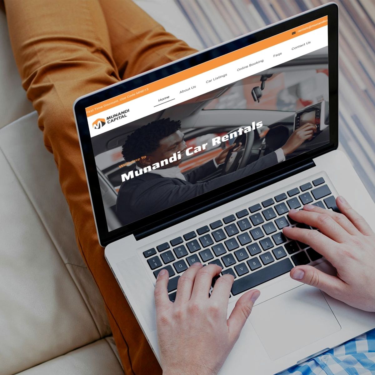 Munandi Car Rental System shown on a laptop