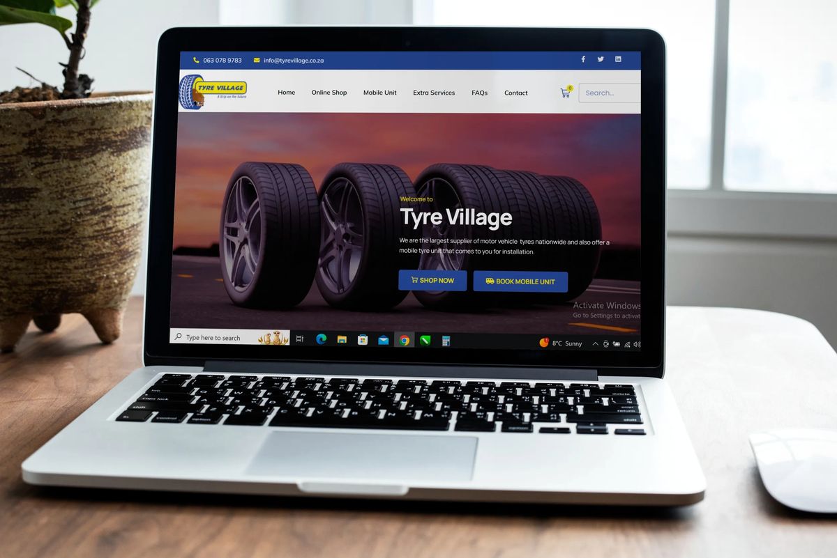 Tyre Village online shop and tyre booking system shown on a laptop