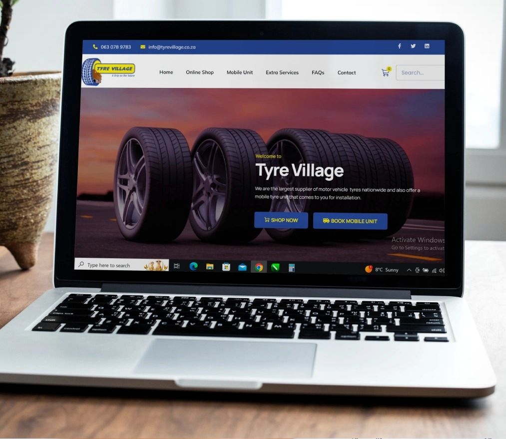 Tyre Village online shop home page shown on a laptop